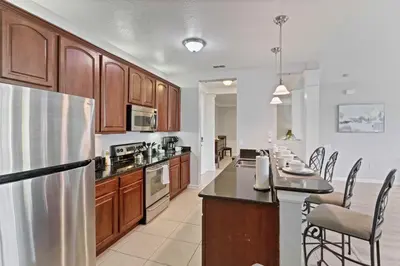 a kitchen with wooden cabinets and a stainless steel refrigerator at 4804 Cayview Avenue 305 in Orlando