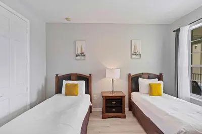 a bedroom with two beds and a table with a lamp at 4804 Cayview Avenue 305 in Orlando
