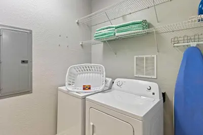 a laundry room with a white washer and dryer at 4804 Cayview Avenue 305 in Orlando
