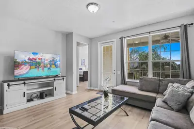 a living room with a couch and a flat screen tv at 4804 Cayview Avenue 305 in Orlando