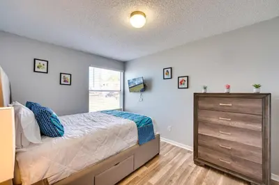 a bedroom with a bed and a dresser and a window at Kissimmee Vacation Rental - 5 Mi to Disney World! in Kissimmee