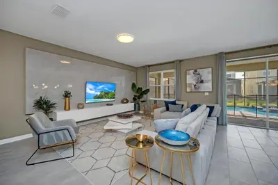 a living room with a couch and a table at 9 Bedrooms 5 Bathrooms Storey Lake 2854 Bd in Kissimmee
