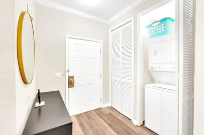 a white room with a refrigerator and a mirror at Near Disney - 3BR Condo - Pool and Games in Orlando