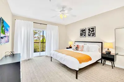 a bedroom with a large bed and a window at 3BR Condo - Pool Sauna - Near Disney in Orlando