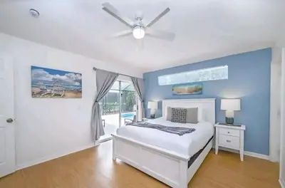 a bedroom with a bed and a ceiling fan at Relaxing, Private Family Home At Lake Berkley Resort, South Facing Pool, Near Disney, SeaWorld in Kissimmee