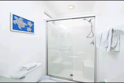 a shower with a glass door in a bathroom at Relaxing, Private Family Home At Lake Berkley Resort, South Facing Pool, Near Disney, SeaWorld in Kissimmee