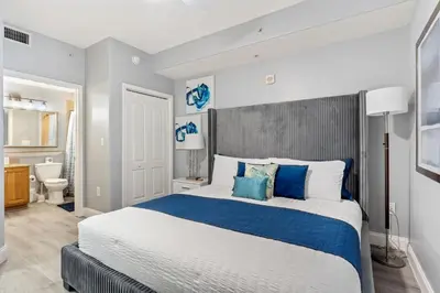a bedroom with a large bed with blue and white pillows at Blue Heron Beach Resort in Orlando