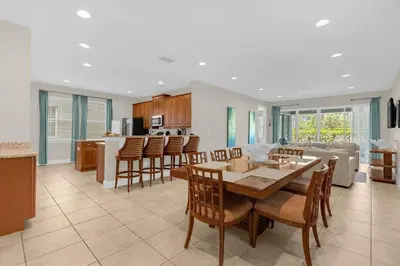 a kitchen and living room with a table and chairs at Multiple Family Homes - 23 Rooms PoolsSpas in Orlando