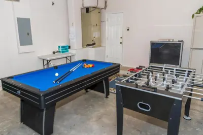 two pool tables in a room with a tv at Home With A View! in Orlando