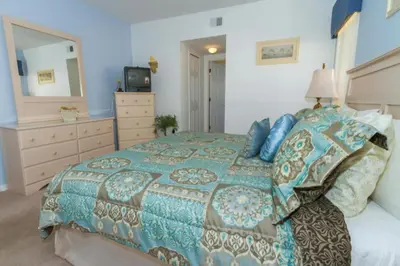 a bedroom with a large bed and a dresser at Home With A View! in Orlando