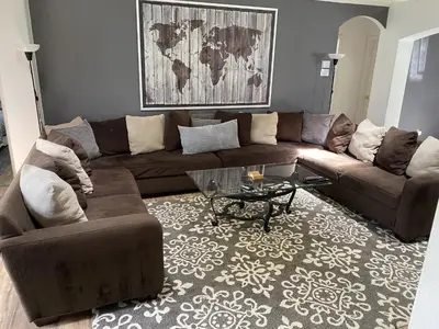 a living room with a brown couch and a coffee table at Just Wanna Have Sun! in Orlando