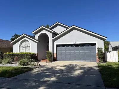 a white house with a garage at Just Wanna Have Sun! in Orlando