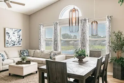 a living room with a table and a couch at THIS IS PARADISE FOUND! Private In-Ground Pool Home, Views, Near Dis, NO Steps, LOW Rates! in Kissimmee