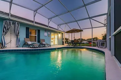 a swimming pool with a tent over it at THIS IS PARADISE FOUND! Private In-Ground Pool Home, Views, Near Dis, NO Steps, LOW Rates! in Kissimmee