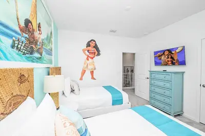 a bedroom with two beds and a tv on the wall at Near Disney - 12BR Home - Private Pool and Hot Tub in Kissimmee