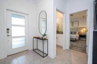 a living room with a mirror and a hallway at Brand new fantastic home at Storey lake (SL4447) in Kissimmee