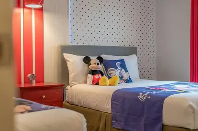 a teddy bear sitting on top of a bed at Find your Cozy home 8 minutes near Disney and Universal in Orlando