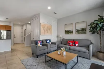 a living room with two couches and a table at Find your Cozy home 8 minutes near Disney and Universal in Orlando