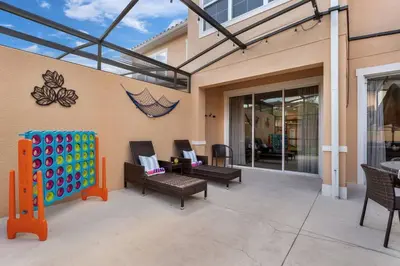 a covered patio with chairs and a giant inflatable at Find your Cozy home 8 minutes near Disney and Universal in Orlando