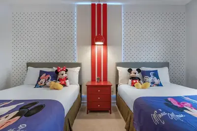 two beds with stuffed animals on them in a bedroom at Find your Cozy home 8 minutes near Disney and Universal in Orlando