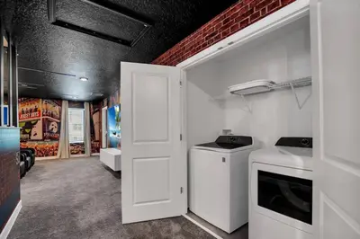 a kitchen with a washer and dryer in a room at Perfect Disney Vacation Home in Kissimmee