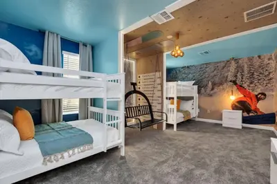 a kids room with bunk beds and blue walls at Perfect Disney Vacation Home in Kissimmee