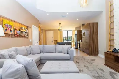 a living room with a couch and a table at Modern and Luxury 4 suites Villa near Disney 7521 in Orlando