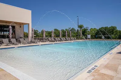 a large swimming pool with water fountains at Modern and Luxury 4 suites Villa near Disney 7521 in Orlando