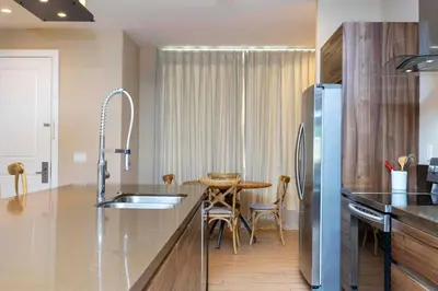 a kitchen with a sink and a table in it at Modern and Luxury 4 suites Villa near Disney 7521 in Orlando