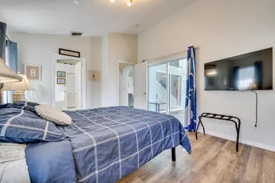 a bedroom with a blue bed and a window at 4 Mi to Disney Family Getaway with Game Room! in Kissimmee