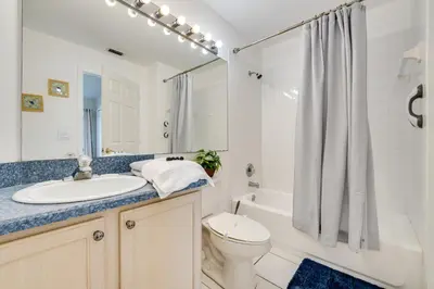 a bathroom with a sink and a toilet and a tub at 4 Mi to Disney Family Getaway with Game Room! in Kissimmee