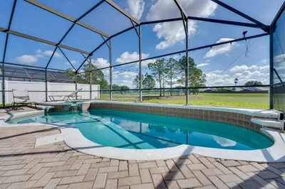 an indoor swimming pool with a glass roof at 4 Mi to Disney Family Getaway with Game Room! in Kissimmee