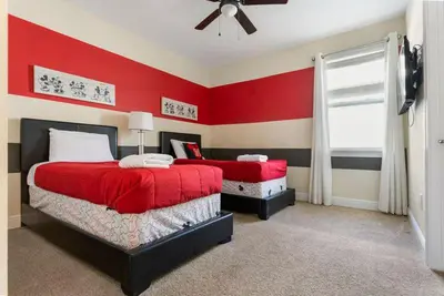 a red bedroom with two beds and a window at Multiple Family Homes 16 Rooms - PoolSpa in Orlando