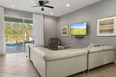 a living room with a couch and a tv at Multiple Family Homes 16 Rooms - PoolSpa in Orlando