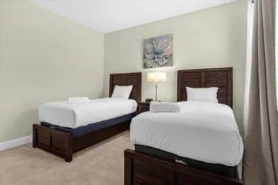 two beds in a hotel room with white sheets at Multiple Family Homes 16 Rooms - PoolSpa in Orlando