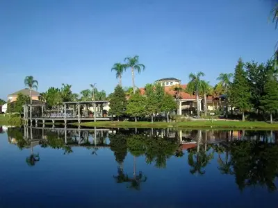 a view of a lake with houses and palm trees at Cozy Private Home at Terra Verde Resort, South Facing Pool Spa, Near Disney, SeaWorld in Kissimmee