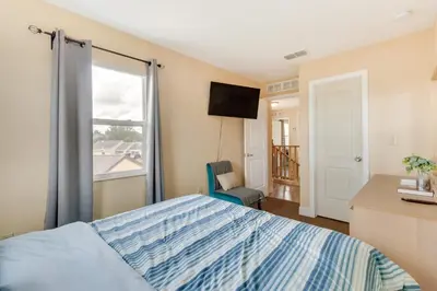 a bedroom with a bed and a large window at 25 Mi to Disney Home with Shared Pool in Orlando in Orlando