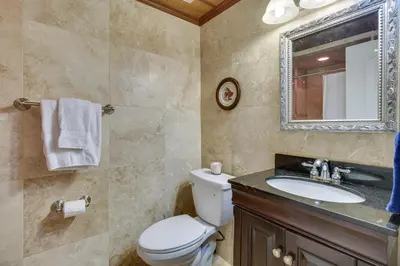 a bathroom with a toilet and a sink and a mirror at Near Kayak Launch Riverfront Home in Sanford! in Sanford