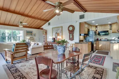 a kitchen and living room with a wooden ceiling at Near Kayak Launch Riverfront Home in Sanford! in Sanford