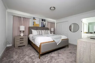 a bedroom with a large bed and a mirror at Marvelous 4Bd with Pool at Storey Lake Resort 2601 in Kissimmee