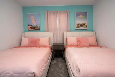 two beds sitting next to each other in a room at Marvelous 4Bd with Pool at Storey Lake Resort 2601 in Kissimmee