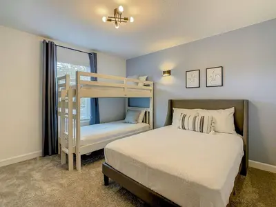 a bedroom with a bed and a bunk bed at 4BR Townhouse with Private Pool near Disney in Kissimmee