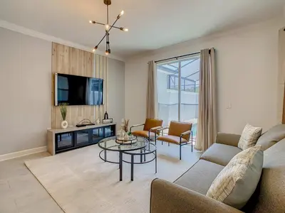 a living room with a couch and a table at 4BR Townhouse with Private Pool near Disney in Kissimmee