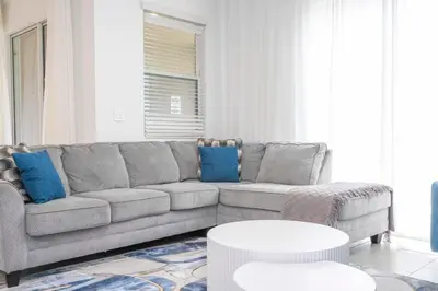 a living room with a couch and a table at 2941 Modern Four Bedroom Locate at Storey Lake in Kissimmee