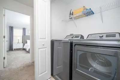 a kitchen with a washer and dryer in a room at 2941 Modern Four Bedroom Locate at Storey Lake in Kissimmee