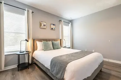 a bedroom with a large bed and a window at Family Retreat 6BR Villa with Private Pool, Spa & Theater near Disney in Kissimmee