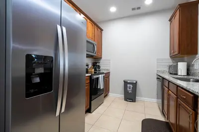 a kitchen with a stainless steel refrigerator at Location Location Orlando Resort Near All Parks! Int'l Dr in Orlando