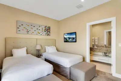 a hotel room with two beds and a sink at Luxury Townhouse located NEXT to DISNEY ORLANDO in Orlando