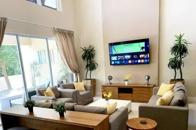 a living room with two couches and a flat screen tv at Luxury Townhouse located NEXT to DISNEY ORLANDO in Orlando