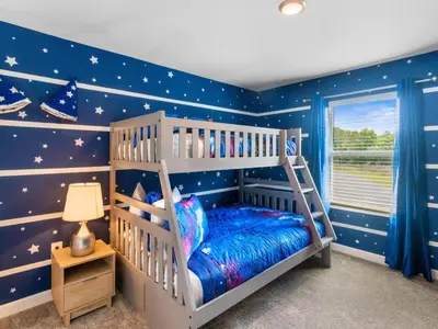 a childs bedroom with stars on the wall at Gorgeous Condo Close to Disney w Private Pool BBQ - Themed Bedrooms Walk To Clubhouse in Kissimmee